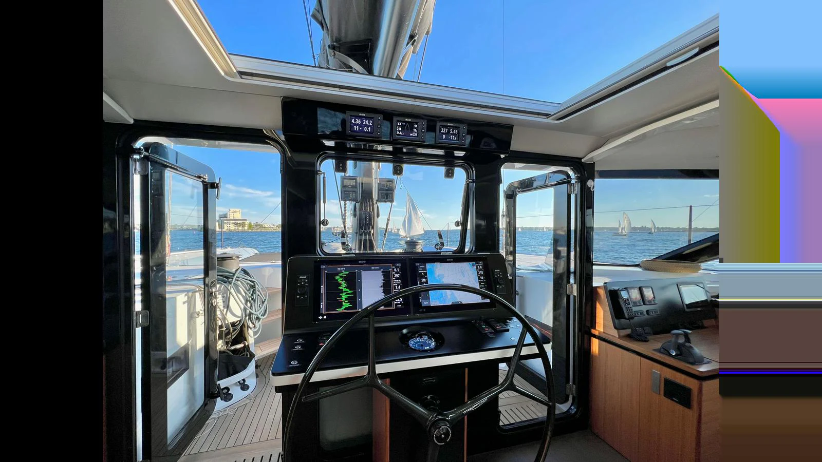 The helm station offers a commanding view with state-of-the-art navigation equipment and a sleek design. aboard GUNBOAT 80 Yacht for Sale