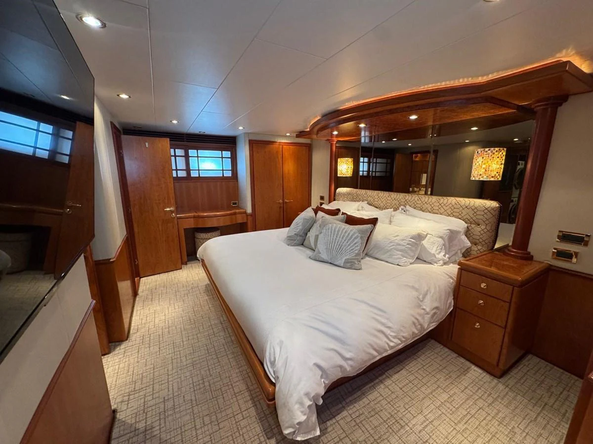 The master stateroom features a luxurious bed with elegant wood finishes and soft lighting. aboard 68' HARGRAVE OPEN BRIDGE Yacht for Sale
