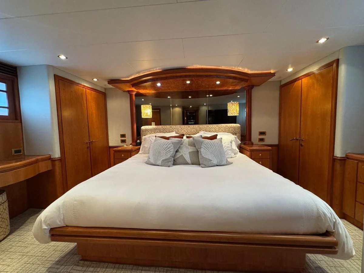 The master stateroom features a luxurious bed with elegant wooden accents and ample storage. aboard 68' HARGRAVE OPEN BRIDGE Yacht for Sale