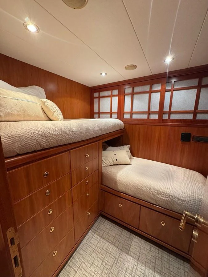 A cozy cabin with wooden finishes and two single beds, perfect for a comfortable stay. aboard 68' HARGRAVE OPEN BRIDGE Yacht for Sale
