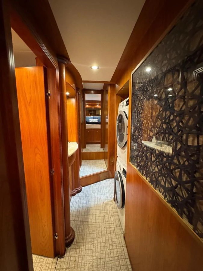 A cozy hallway in the yacht's interior featuring wooden paneling and a laundry area. aboard 68' HARGRAVE OPEN BRIDGE Yacht for Sale