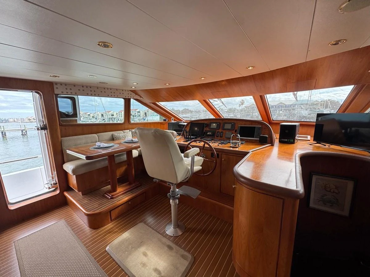 The helm station features a luxurious wooden finish with panoramic windows offering a stunning view. aboard 68' HARGRAVE OPEN BRIDGE Yacht for Sale