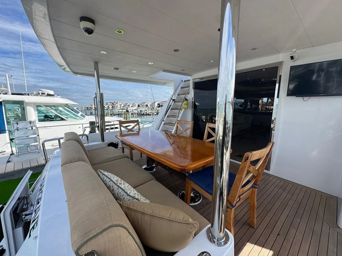 The aft deck features a spacious dining area with a polished wooden table and comfortable seating, perfect for alfresco meals. aboard 68' HARGRAVE OPEN BRIDGE Yacht for Sale