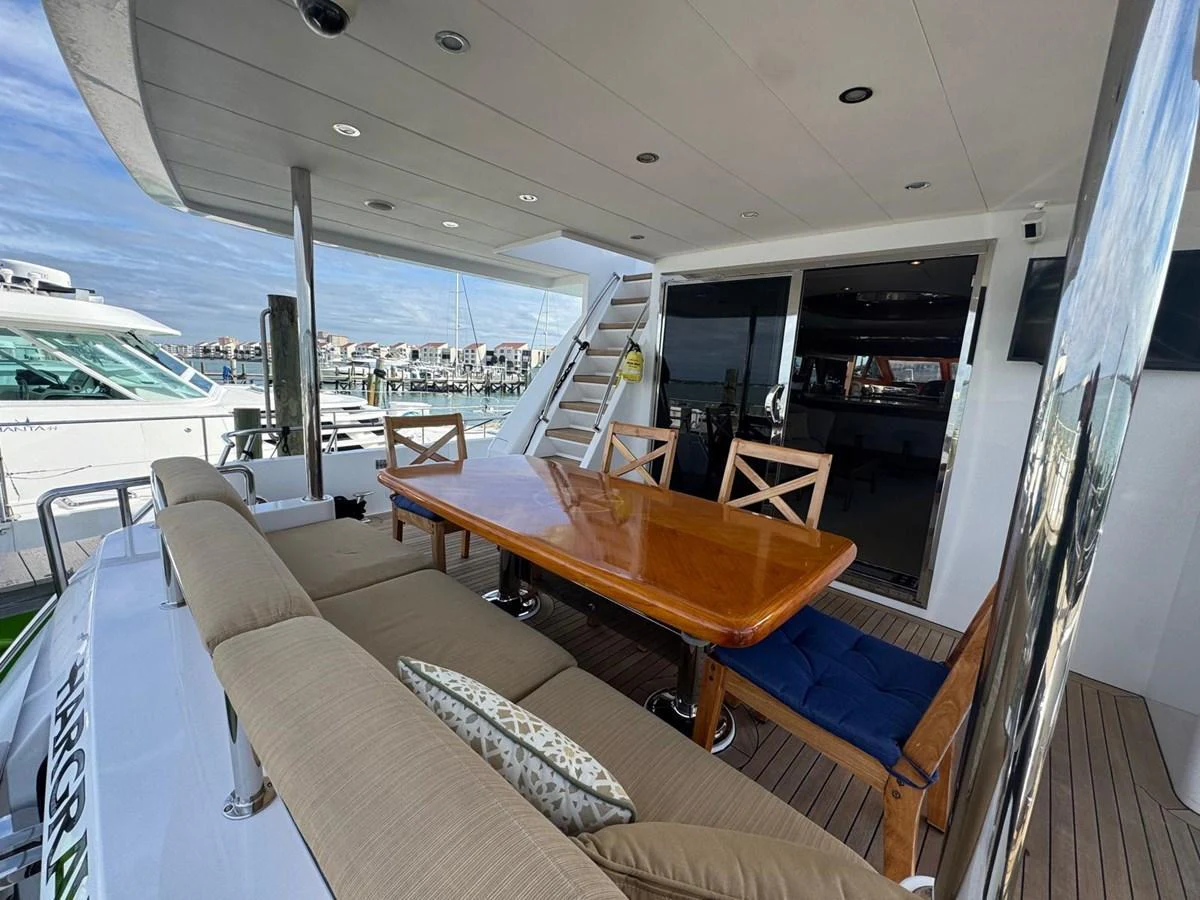 The aft deck features a spacious dining area with a polished wooden table and comfortable seating, perfect for alfresco meals. aboard 68' HARGRAVE OPEN BRIDGE Yacht for Sale