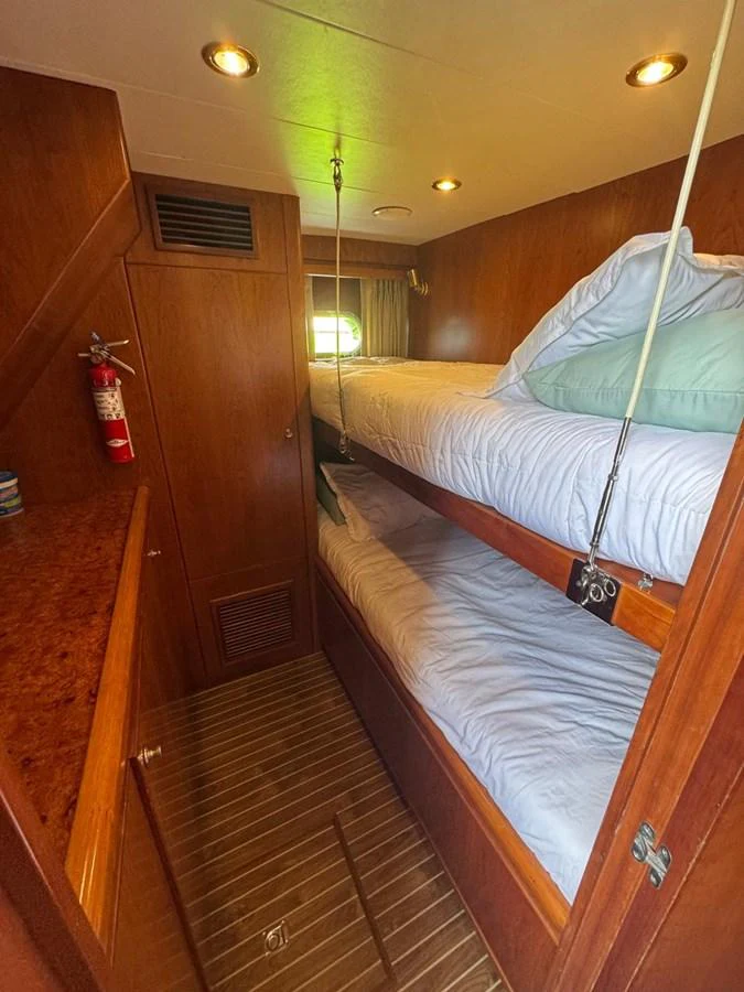 The cozy bunk cabin features wooden paneling and comfortable bedding, perfect for a restful sleep. aboard 68' HARGRAVE OPEN BRIDGE Yacht for Sale
