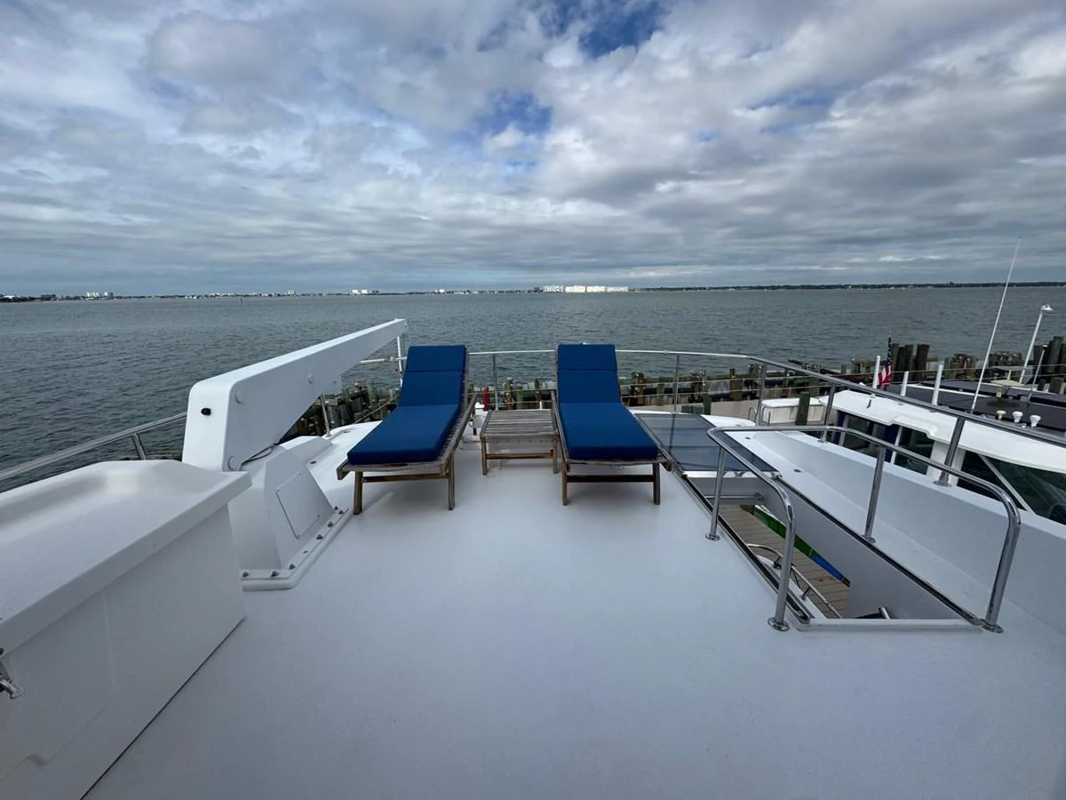 The sundeck offers a serene space with two blue lounge chairs, perfect for relaxation while enjoying the view. aboard 68' HARGRAVE OPEN BRIDGE Yacht for Sale