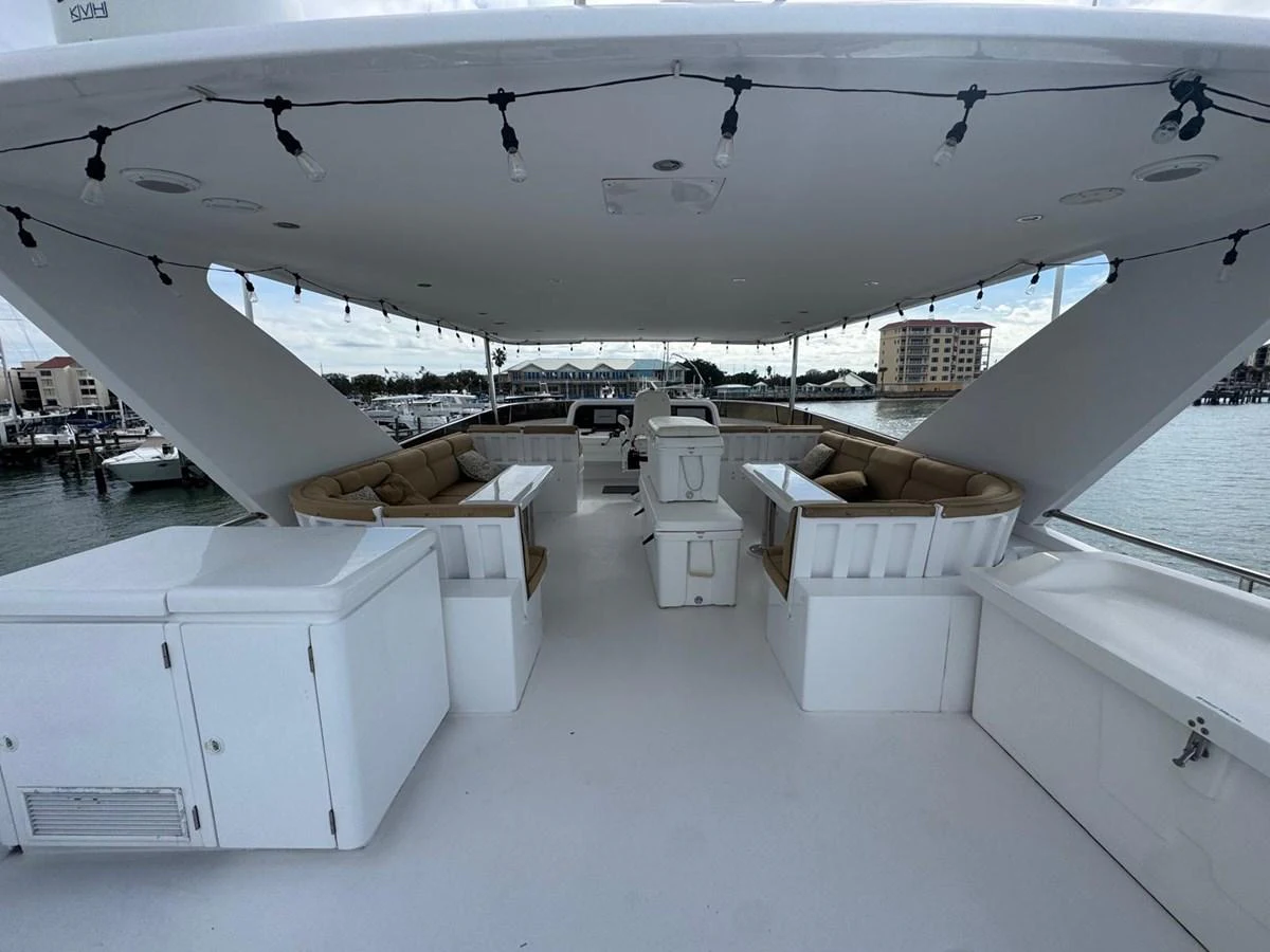 The flybridge offers ample seating and a shaded area for relaxation with a view of the marina. aboard 68' HARGRAVE OPEN BRIDGE Yacht for Sale