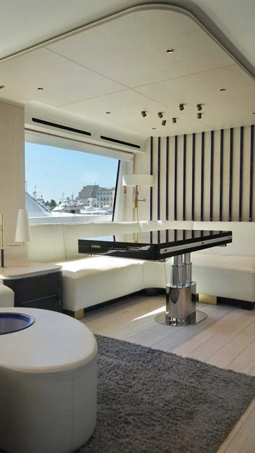 The salon features modern furnishings with ample natural light and a stylish design. aboard KOKO Yacht for Sale