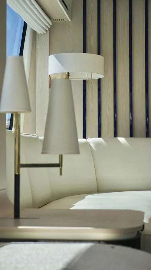 A cozy seating area with elegant lighting fixtures inside the yacht. aboard KOKO Yacht for Sale