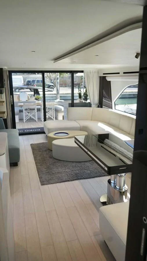 The yacht's salon features a modern and spacious seating area with large windows for natural light. aboard KOKO Yacht for Sale