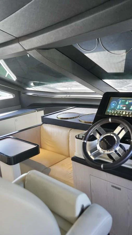 The helm station features modern navigation equipment and a comfortable seating area. aboard KOKO Yacht for Sale