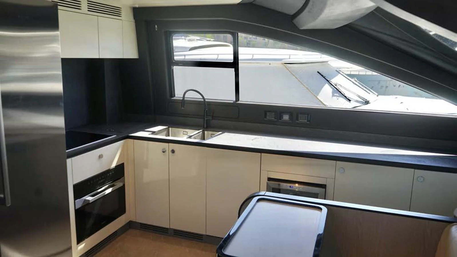 The yacht's galley features modern appliances and a sleek design, perfect for gourmet cooking at sea. aboard KOKO Yacht for Sale