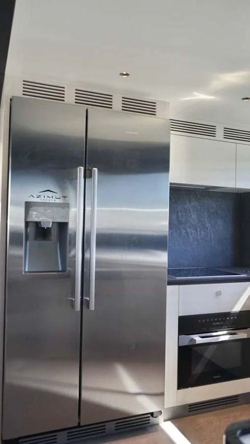 The sleek galley features modern stainless steel appliances and a clean, contemporary design. aboard KOKO Yacht for Sale