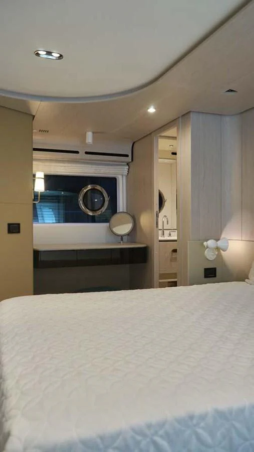 A cozy stateroom with a comfortable bed and modern furnishings. aboard KOKO Yacht for Sale