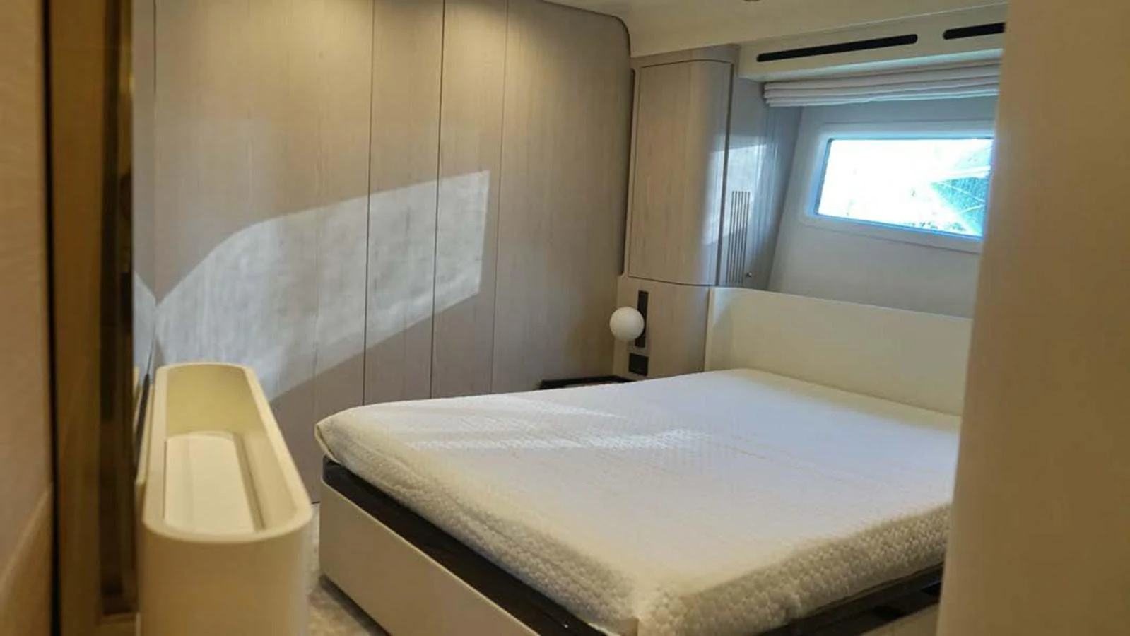 A serene stateroom with a large bed and ample natural light. aboard KOKO Yacht for Sale