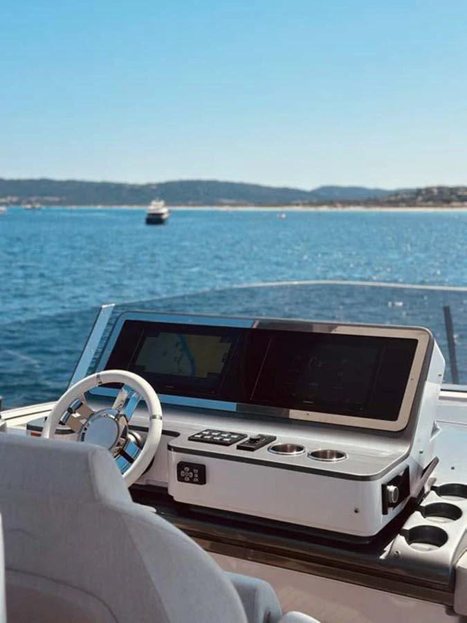 The helm station offers a sleek and modern control center with stunning views of the open water. aboard KOKO Yacht for Sale