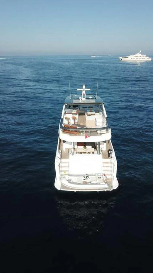 Aerial view of a luxurious yacht on calm blue waters with another yacht in the background. aboard KOKO Yacht for Sale