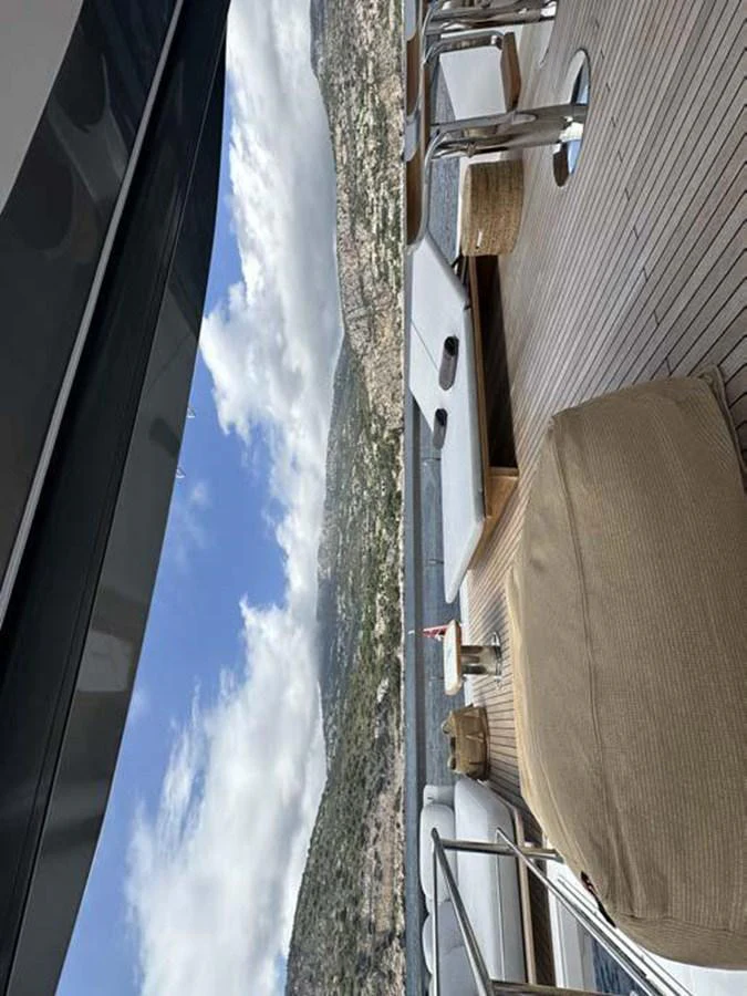 The aft deck offers a luxurious space with comfortable seating and stunning views of the coastline. aboard KOKO Yacht for Sale