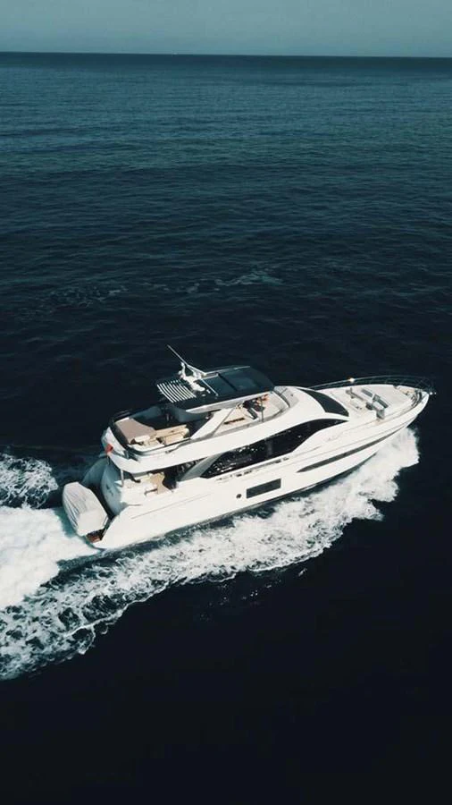 A sleek and modern yacht cruises through the open sea, showcasing its elegant design and luxurious amenities. aboard KOKO Yacht for Sale