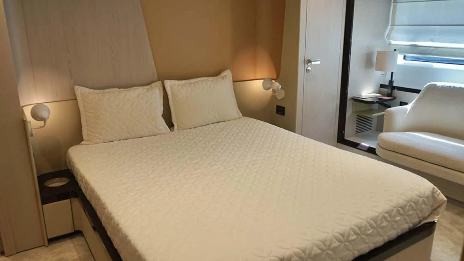 This image showcases a luxurious stateroom with a comfortable bed and modern decor. aboard KOKO Yacht for Sale