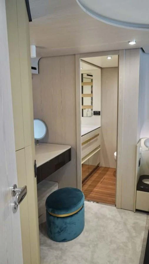 A cozy and well-appointed interior space featuring a vanity area and modern decor. aboard KOKO Yacht for Sale