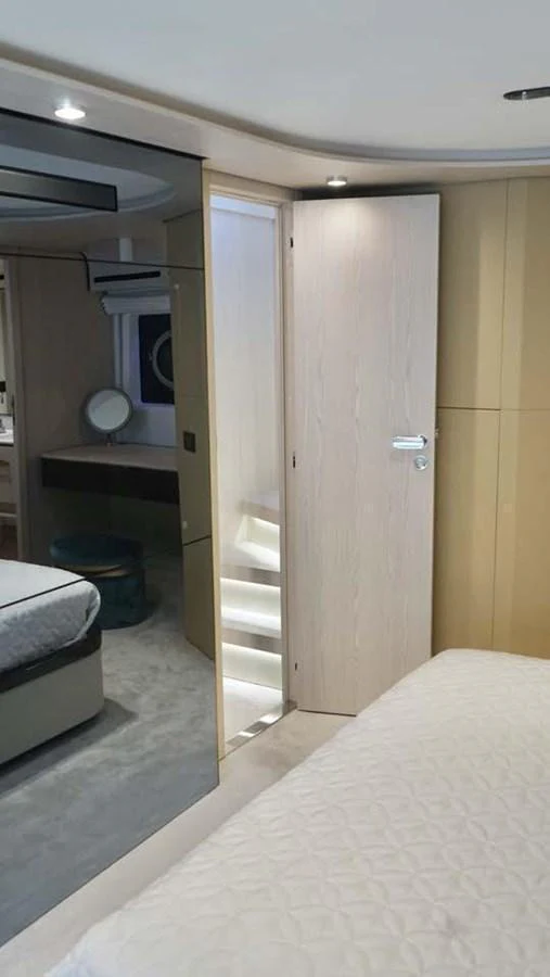 The image showcases a luxurious stateroom with a modern design and elegant furnishings. aboard KOKO Yacht for Sale