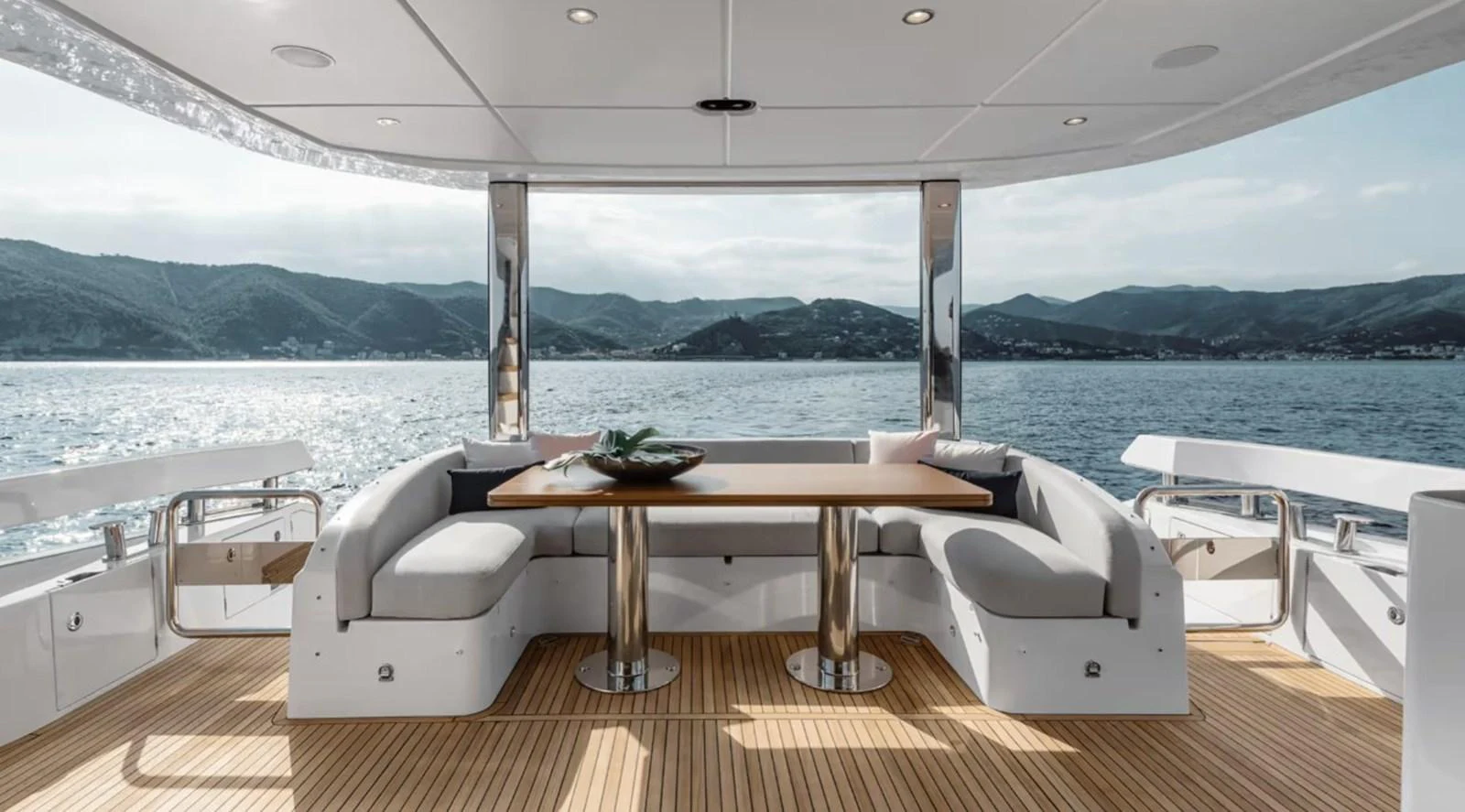 The aft deck features a stylish dining area with panoramic views of the surrounding waters. aboard KOKO Yacht for Sale