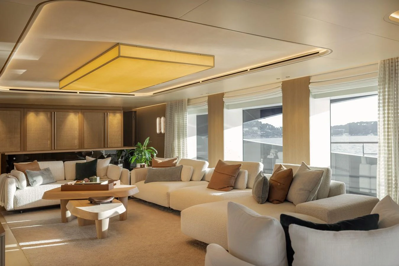 The salon features luxurious seating with ample natural light and elegant decor. aboard SEAWOLF X Yacht for Sale