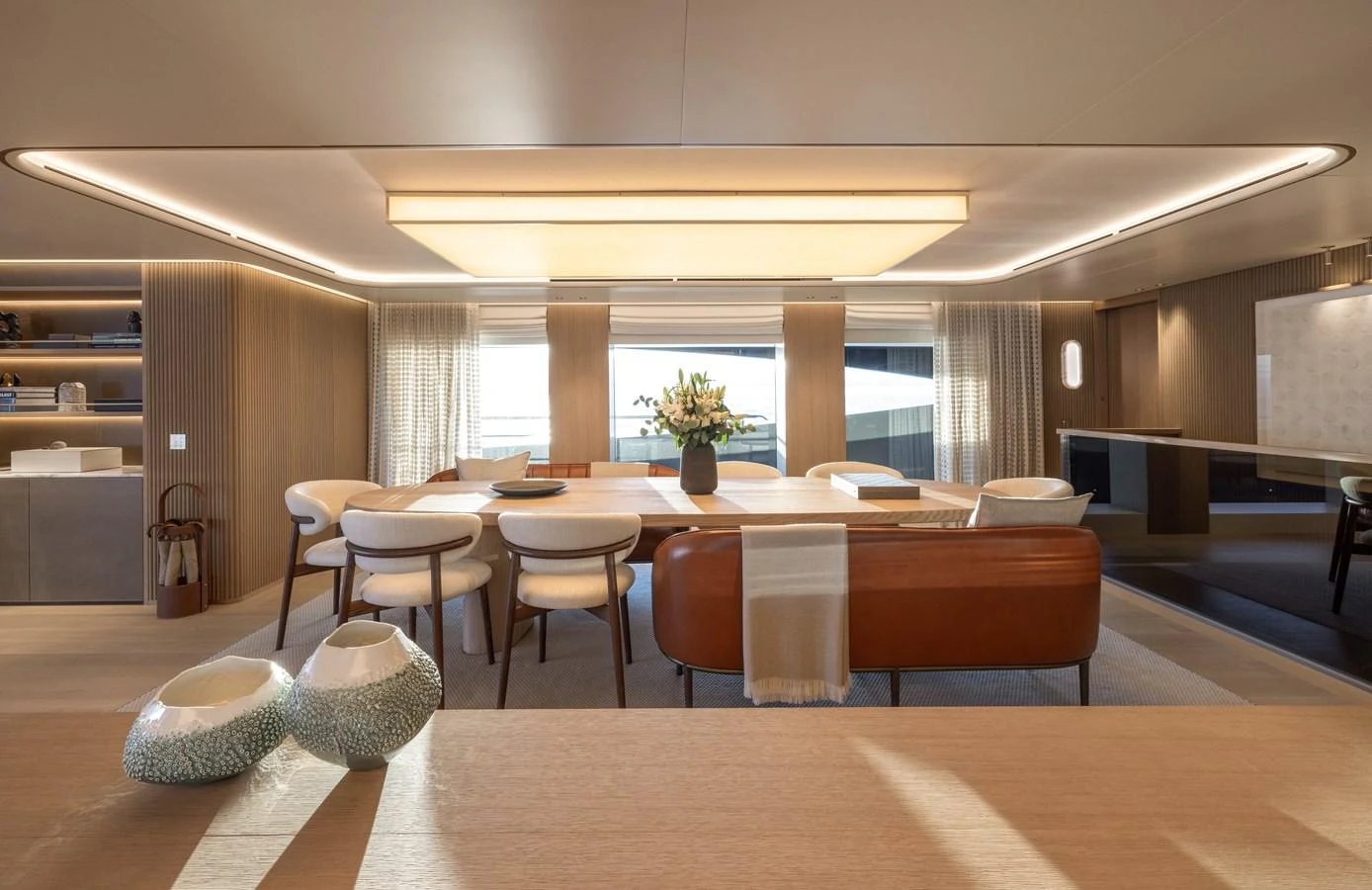 The salon features elegant seating and a sophisticated dining area with ample natural light. aboard SEAWOLF X Yacht for Sale