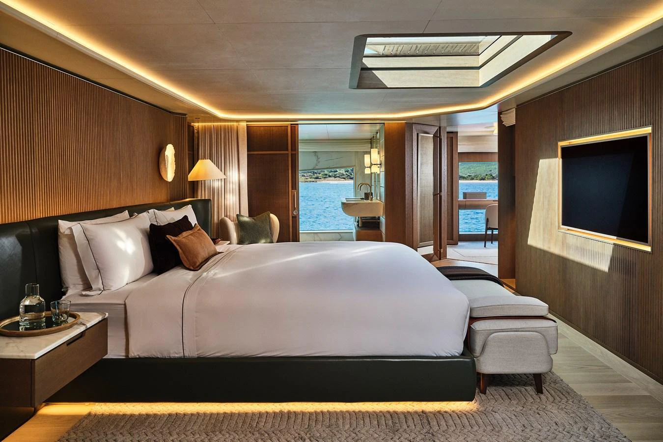 The master stateroom offers a luxurious retreat with a large bed, elegant decor, and a view of the sea. aboard SEAWOLF X Yacht for Sale