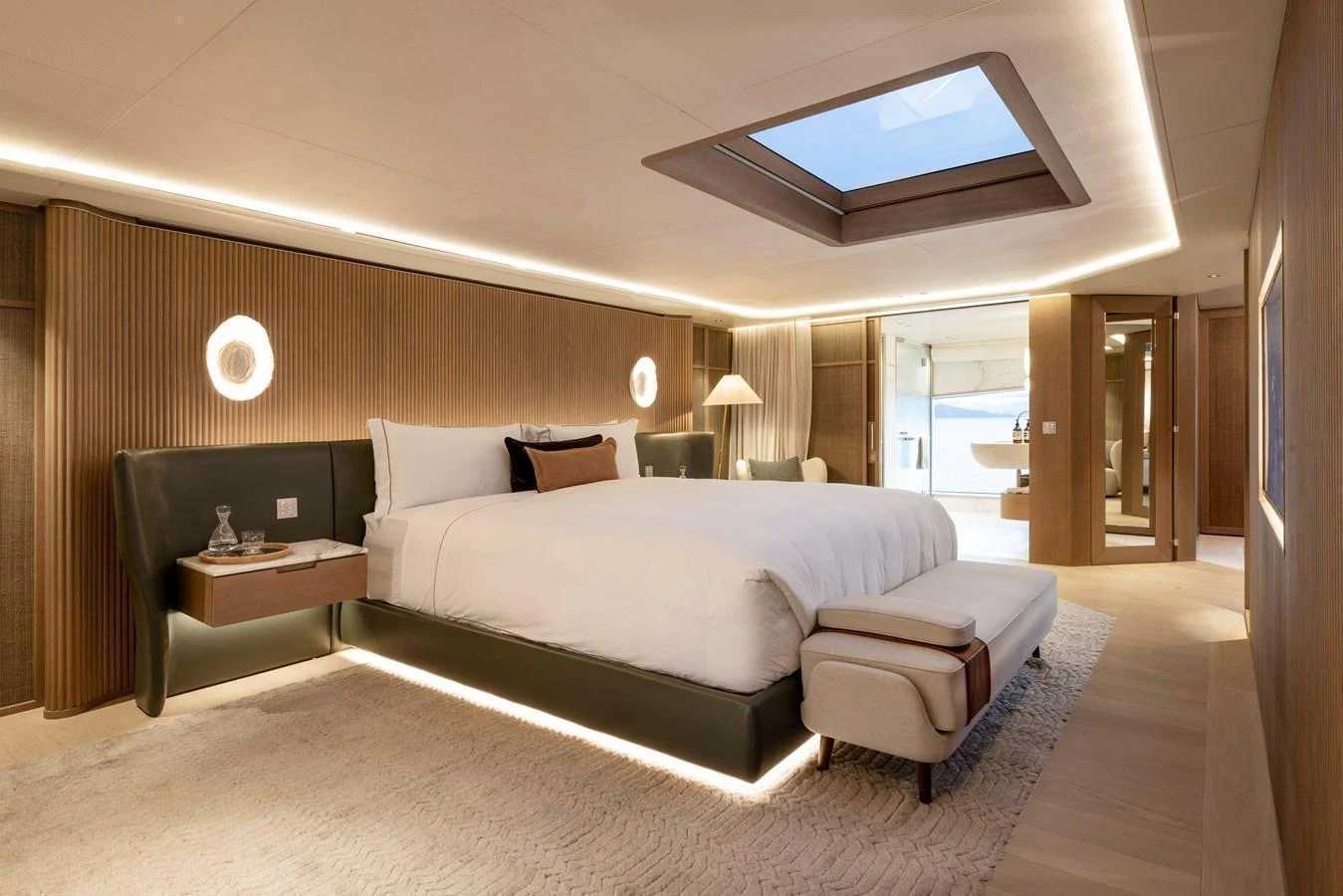 The master stateroom features a luxurious bed, elegant lighting, and a skylight for natural illumination. aboard SEAWOLF X Yacht for Sale