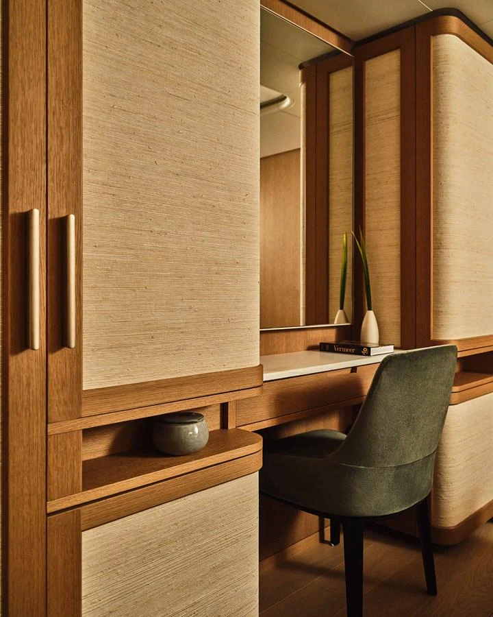 The yacht's interior features a sophisticated vanity area with elegant wood finishes and a plush chair. aboard SEAWOLF X Yacht for Sale