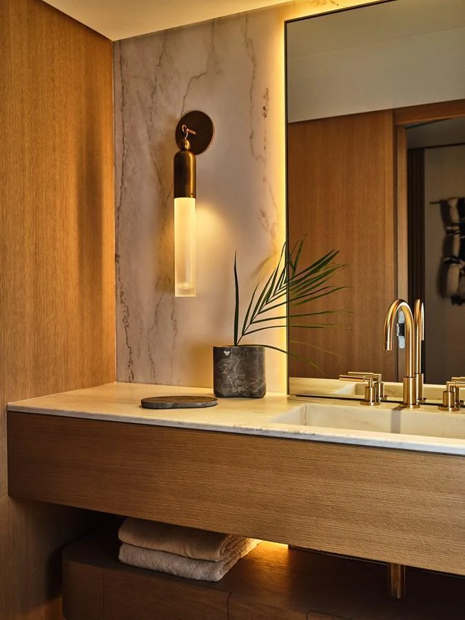 A luxurious bathroom with elegant fixtures and warm lighting. aboard SEAWOLF X Yacht for Sale
