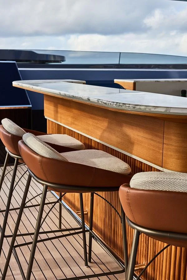 The yacht features a stylish bar area with comfortable seating and a sleek countertop. aboard SEAWOLF X Yacht for Sale