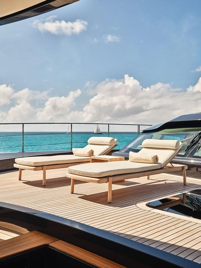 Luxurious sun loungers on the sundeck offer a perfect spot for relaxation with stunning ocean views. aboard SEAWOLF X Yacht for Sale