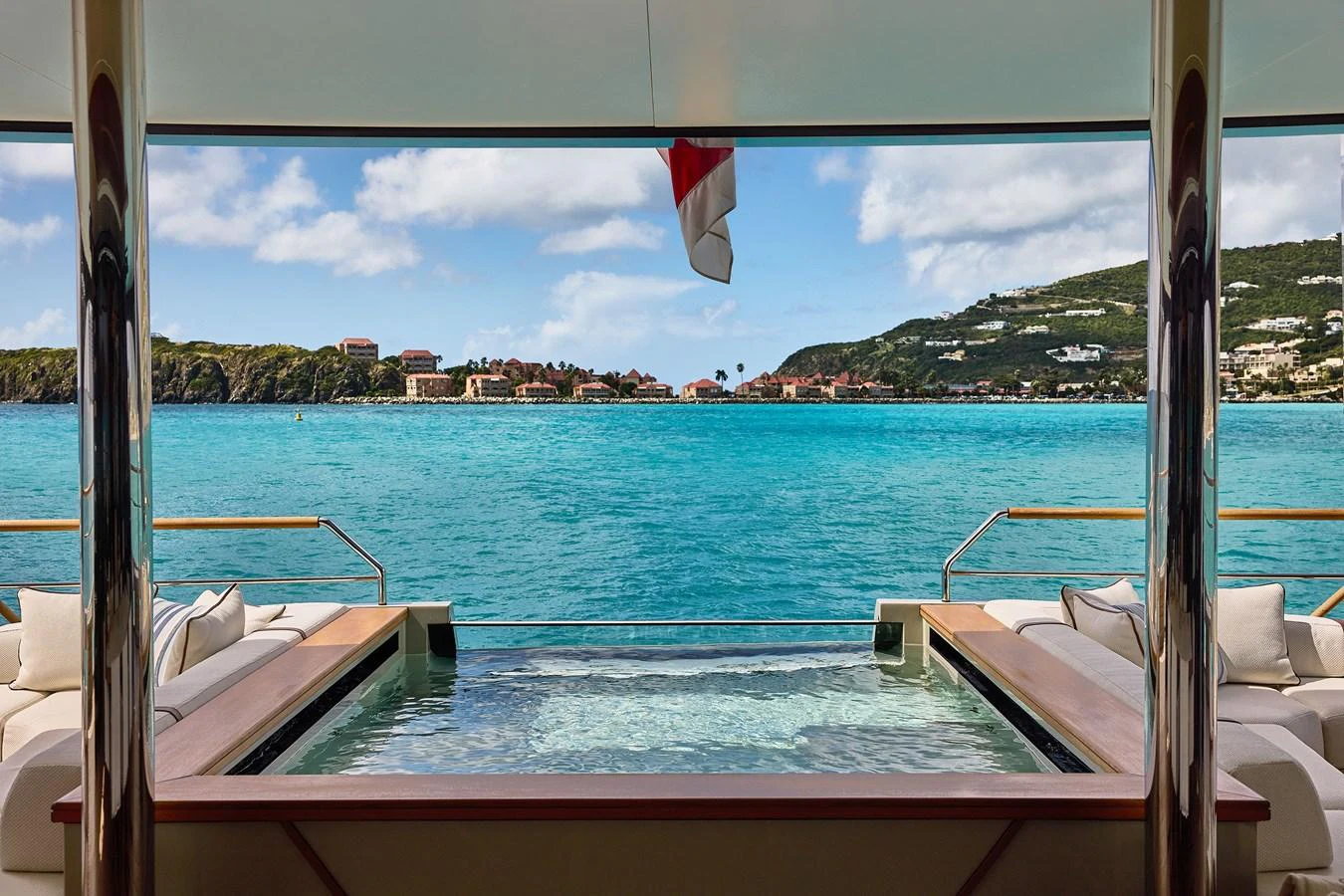 The aft deck features a luxurious pool with stunning views of the surrounding waters and coastline. aboard SEAWOLF X Yacht for Sale