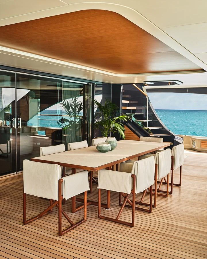The aft deck features a stylish dining area with a beautiful ocean view. aboard SEAWOLF X Yacht for Sale