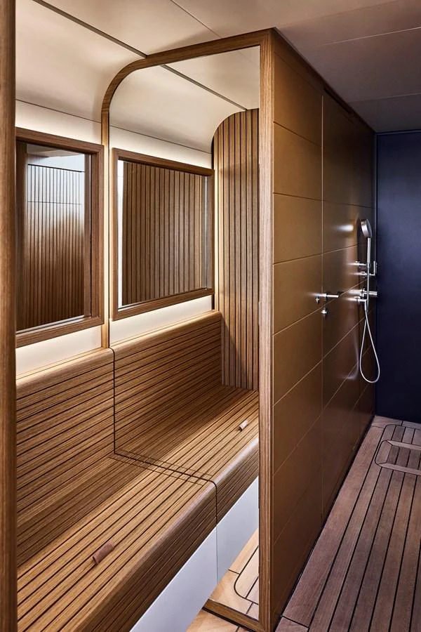 The yacht features a luxurious sauna with sleek wooden paneling and modern fixtures. aboard SEAWOLF X Yacht for Sale