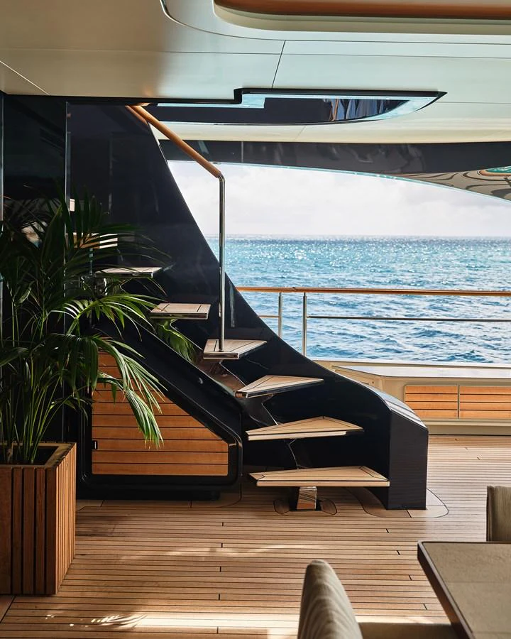 A stylish aft deck with modern staircase and ocean view. aboard SEAWOLF X Yacht for Sale
