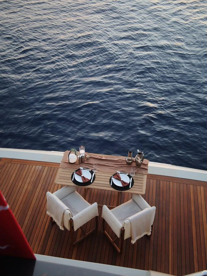 A serene dining setup on the aft deck overlooking the calm sea. aboard SEAWOLF X Yacht for Sale