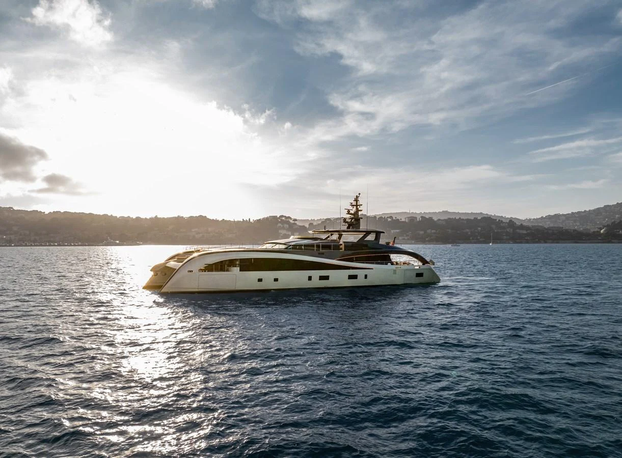 A sleek and modern yacht glides gracefully on the open water against a scenic coastal backdrop. aboard SEAWOLF X Yacht for Sale