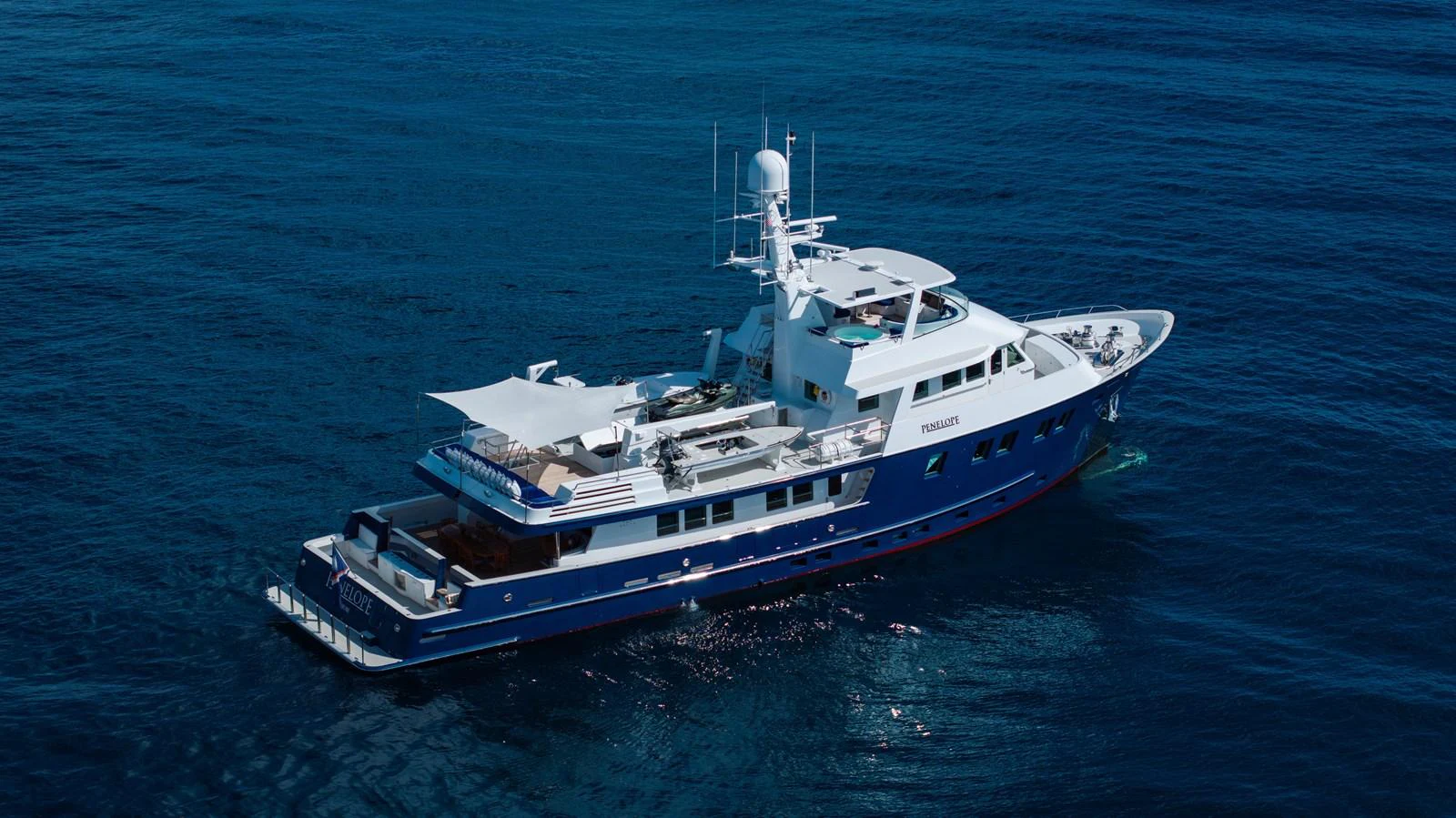 a large boat in the water aboard STAMPEDE Yacht for Sale