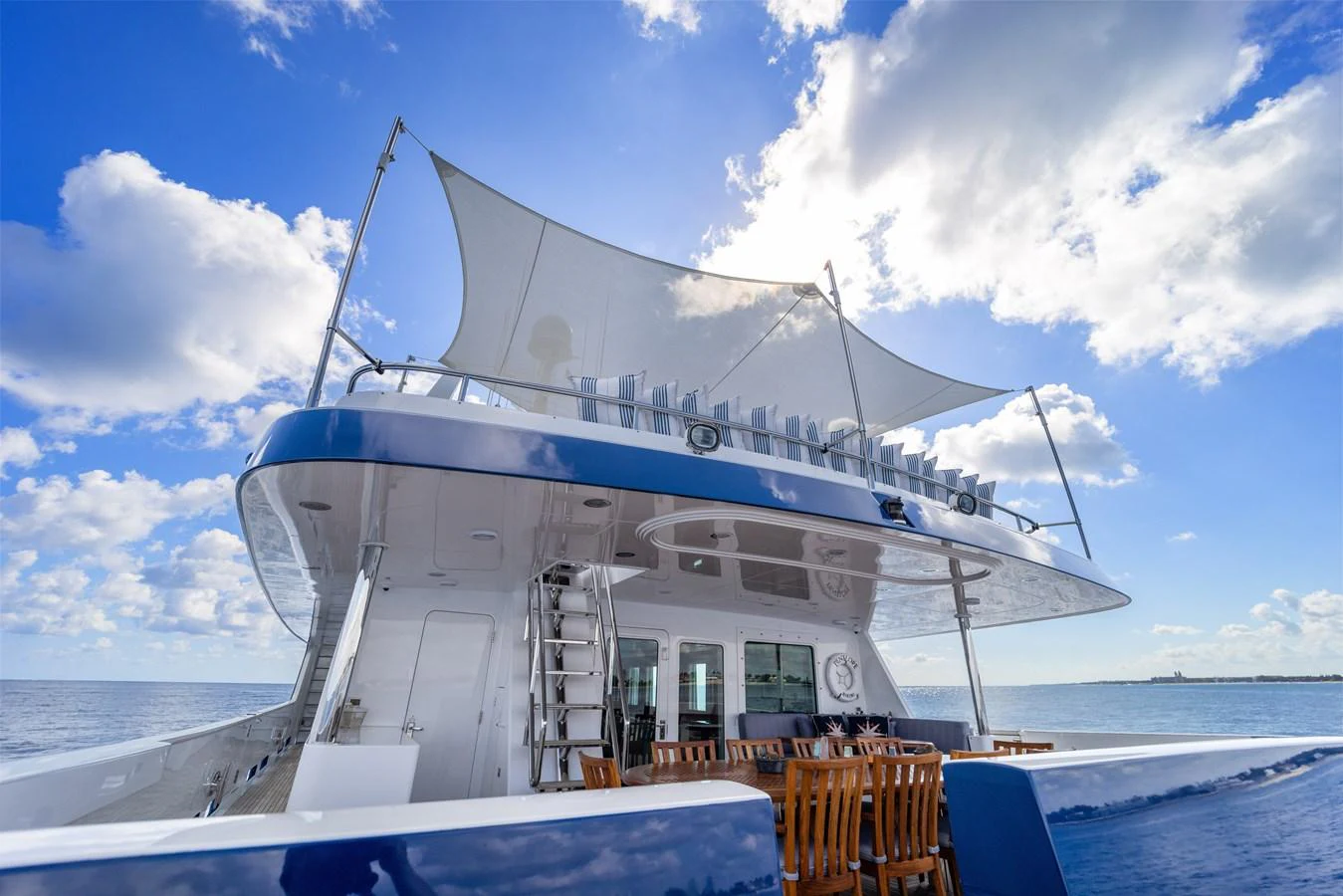 a large white boat on a body of water aboard STAMPEDE Yacht for Sale