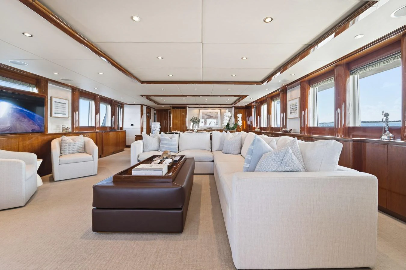 a living room with a couch and a table aboard STAMPEDE Yacht for Sale
