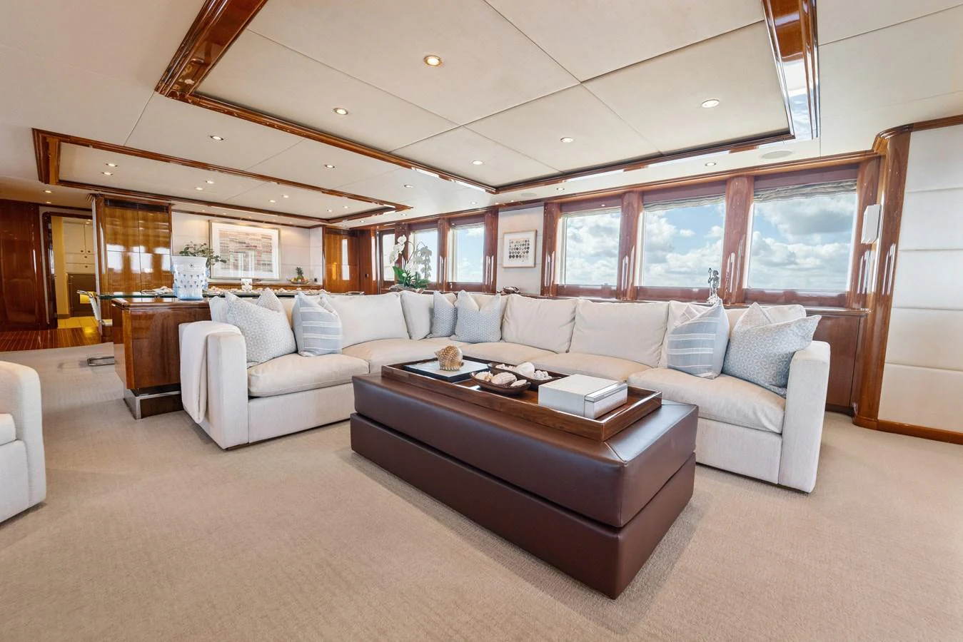 a living room with a couch and a table aboard STAMPEDE Yacht for Sale