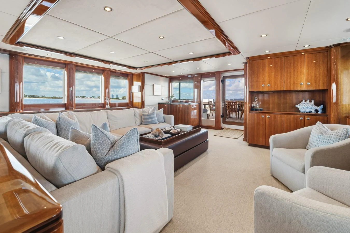 a living room with a large wood cabinet aboard STAMPEDE Yacht for Sale