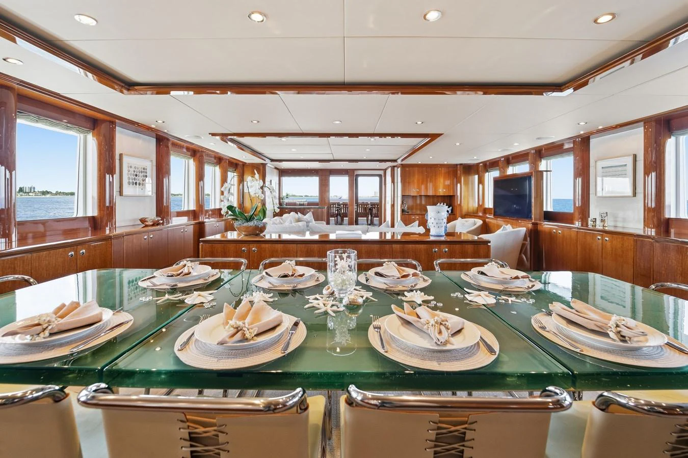 a table with plates and glasses on it aboard STAMPEDE Yacht for Sale