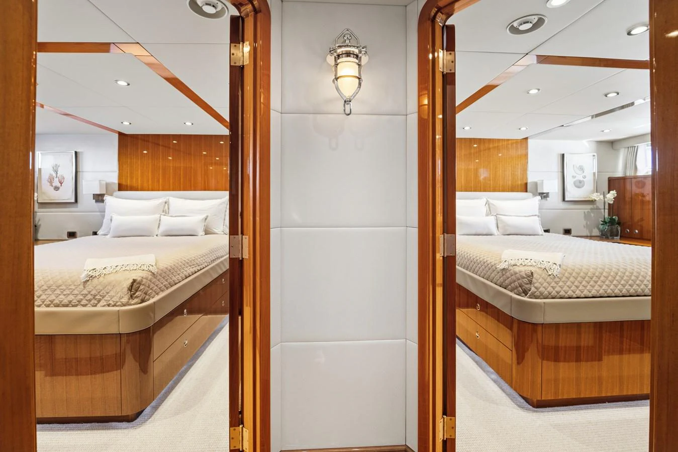 a room with a bed and a mirror aboard STAMPEDE Yacht for Sale
