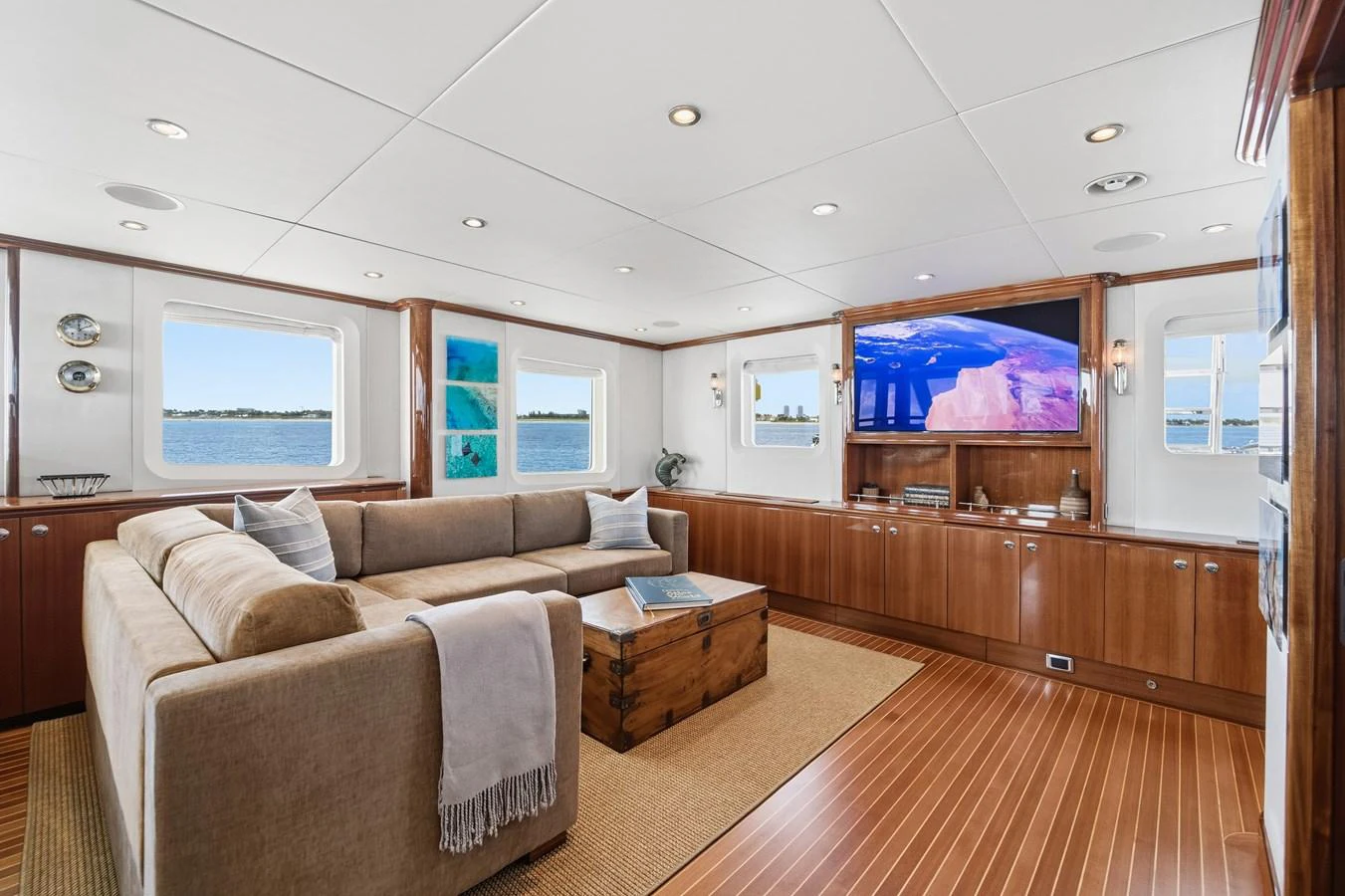 a living room with a couch and a tv aboard STAMPEDE Yacht for Sale