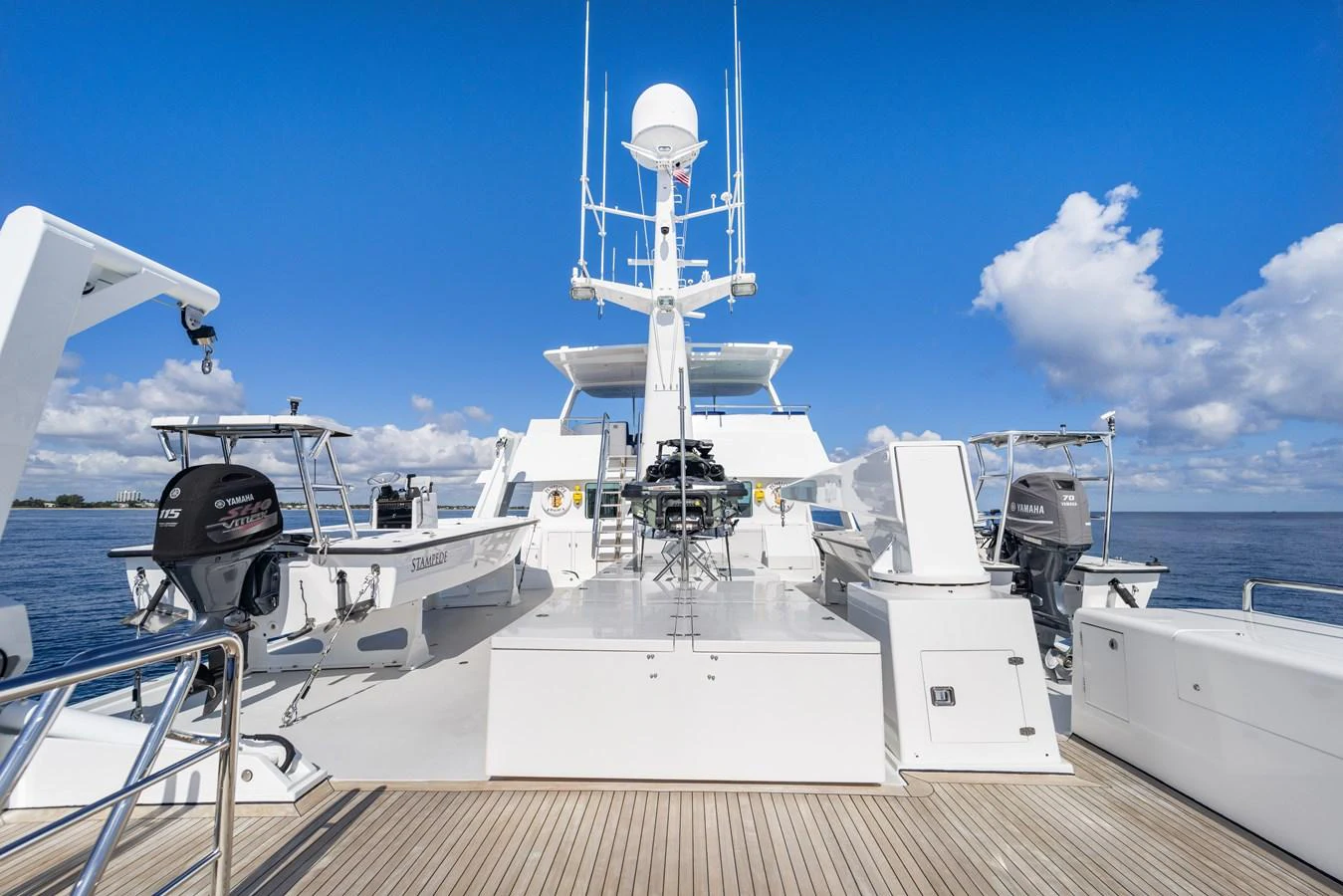 a large white boat with a satellite dish on it aboard STAMPEDE Yacht for Sale